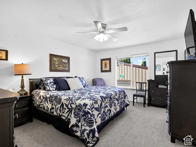 Recessed lighting, ceiling fan, carpet flooring, and a large window
