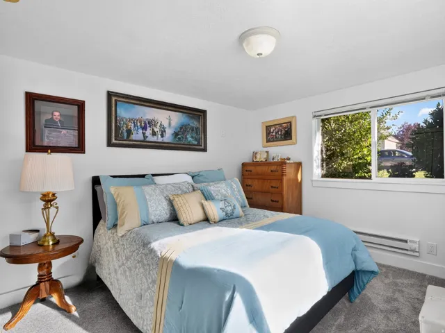 White walls complementing gray carpeting, with a window providing exterior visibility