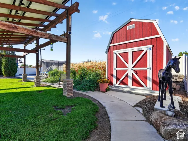 Red barn-style shed with white trim and double doors