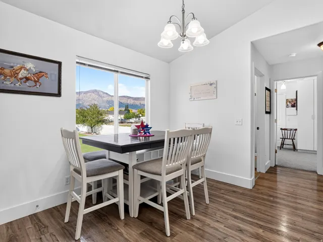 Wood-finish flooring, white walls, and a window with mountain scenery