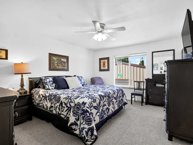 Recessed lighting, ceiling fan, carpet flooring, and a large window