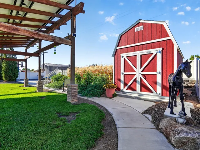 Red barn-style shed with white trim and double doors