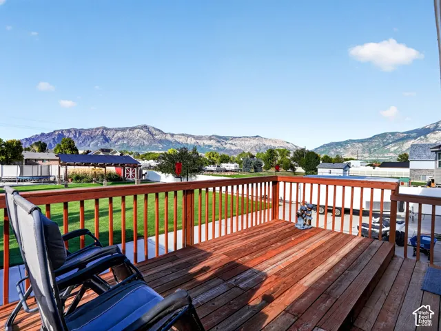 Expansive wood-finish deck with railing, providing an elevated outdoor living space