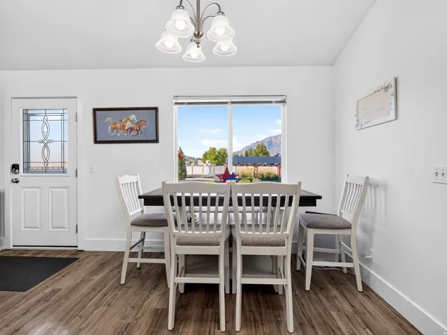 Wood-finish flooring, white walls, and a window with a mountain backdrop