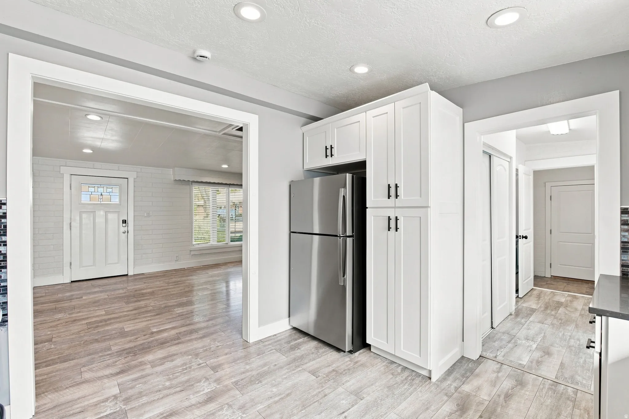 Kitchen showing the entry to laundry room garage, and door to the backyard.