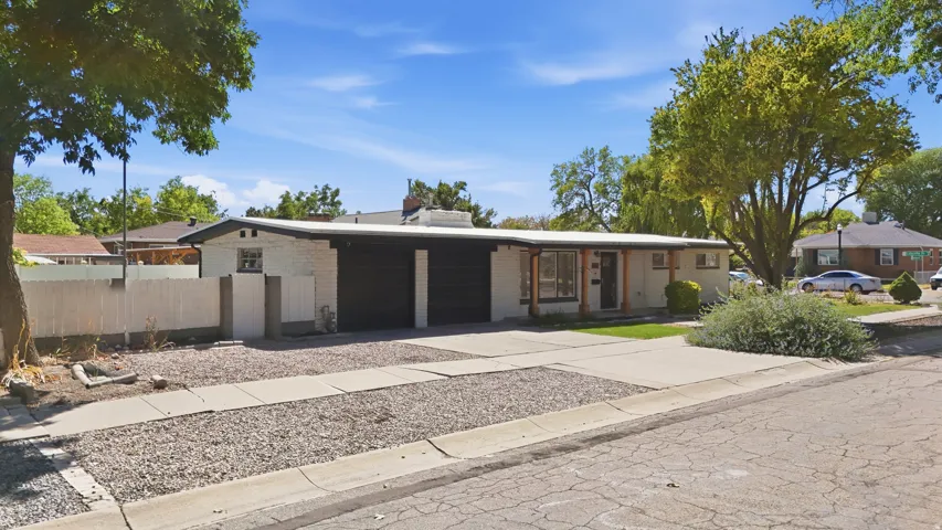 Single-story residence featuring a covered front entry and a dark-colored garage