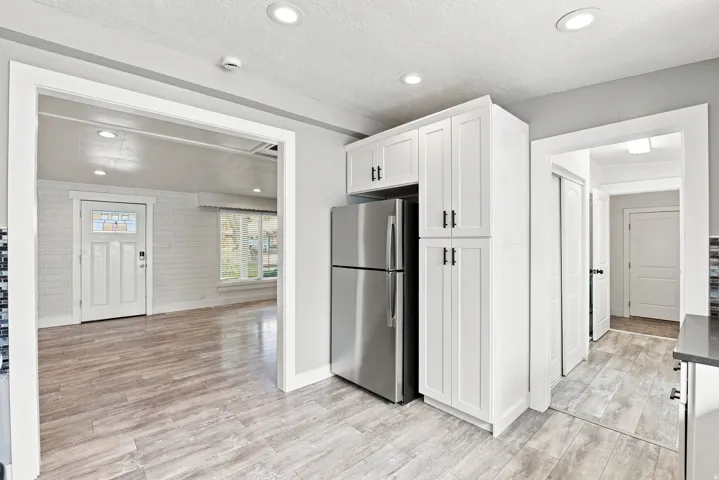 Kitchen showing the entry to laundry room garage, and door to the backyard.