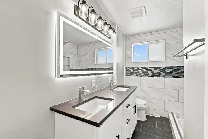Dual vanity with undermount sinks and dark countertops