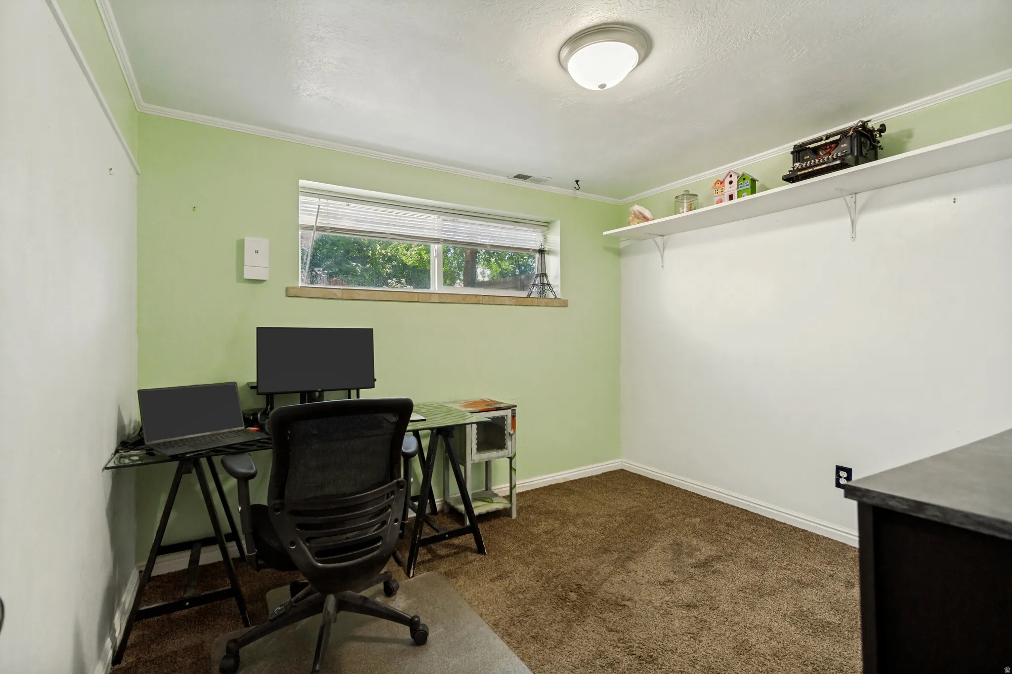 Recessed lighting, crown molding, built-in shelving, window with natural light, and carpeted flooring