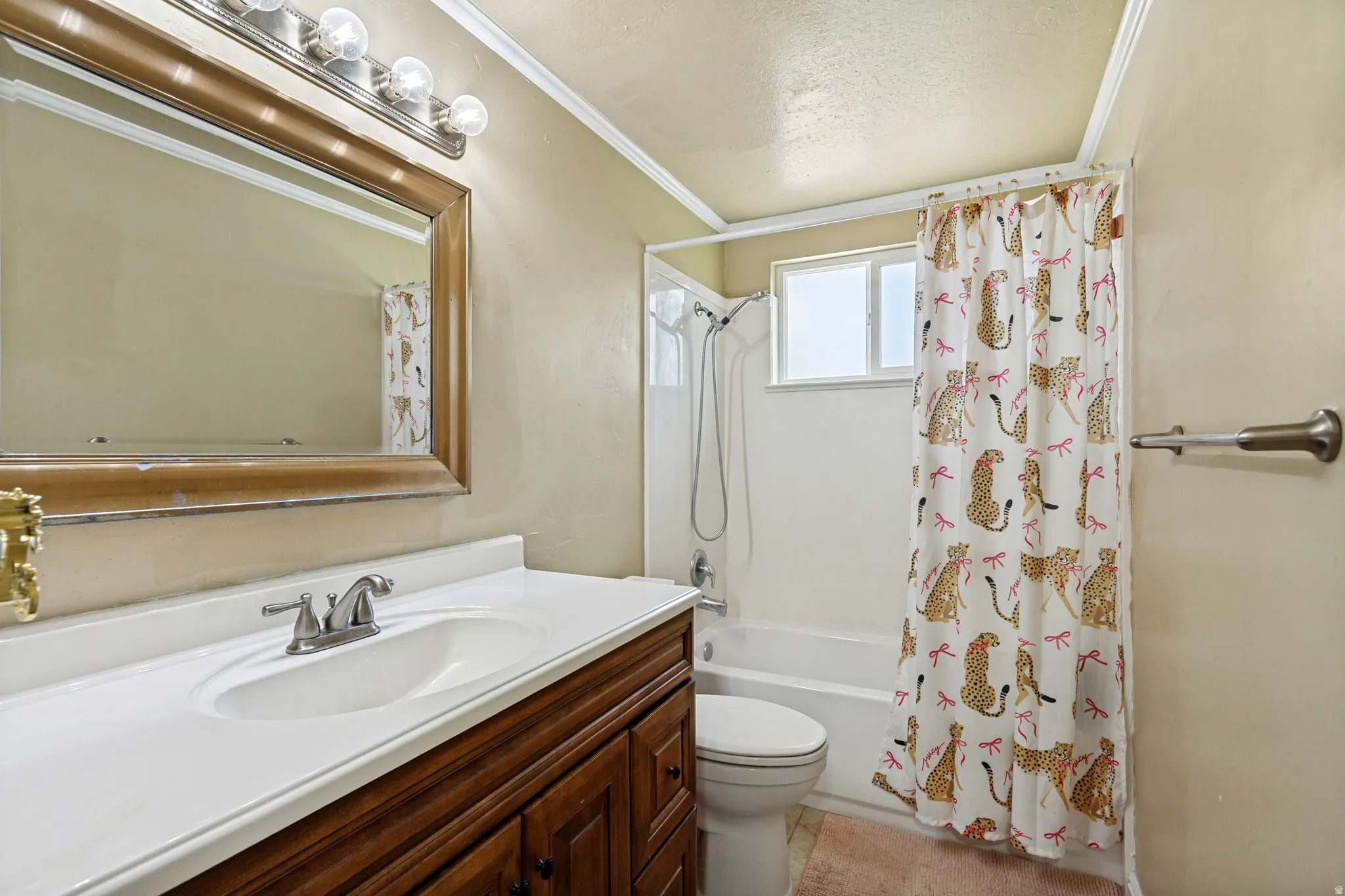 Built-in vanity with a white countertop and integrated sink, chrome faucet, and wood-finish cabinetry