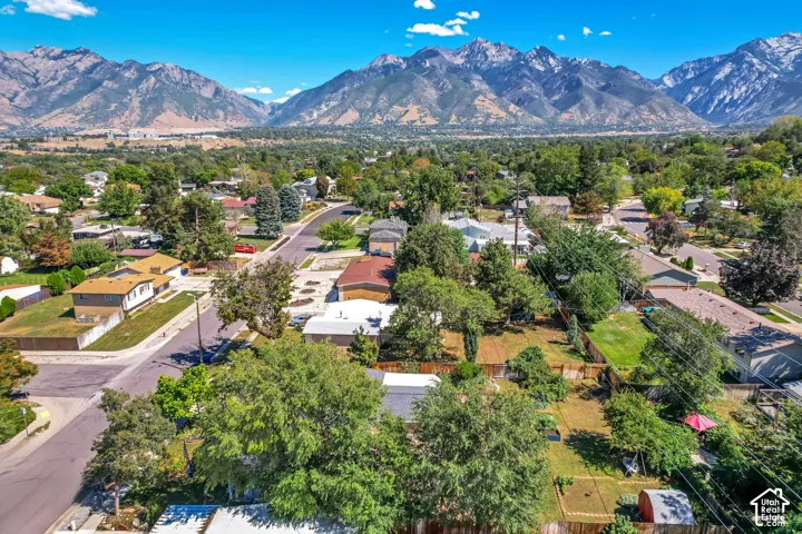 Neighborhood setting featuring mature trees and mountain scenery