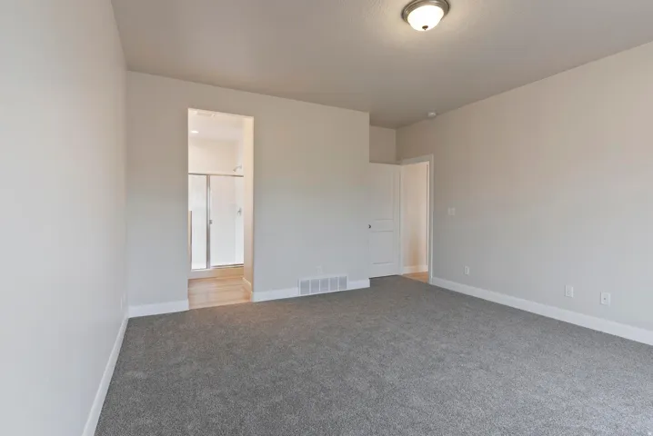 Soft gray carpeting, neutral wall tones, and white trim