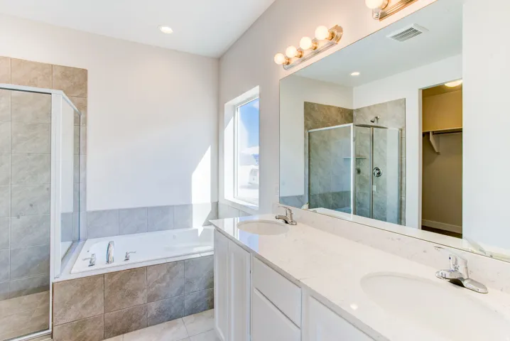 Dual vanity with white cabinetry and light-toned countertop