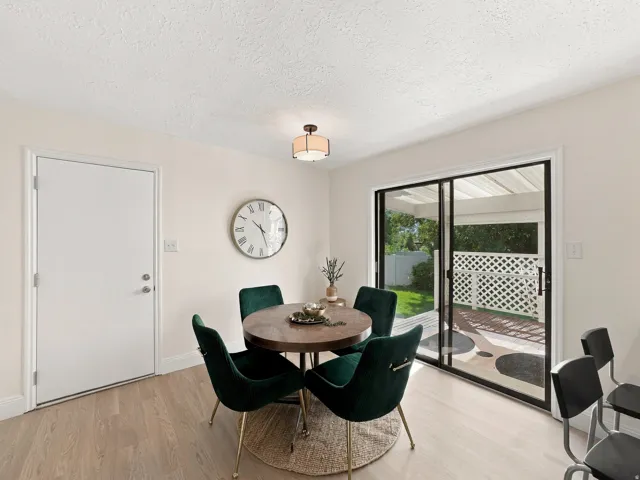 Wood-finish flooring, recessed lighting, and sliding glass doors to outdoor patio