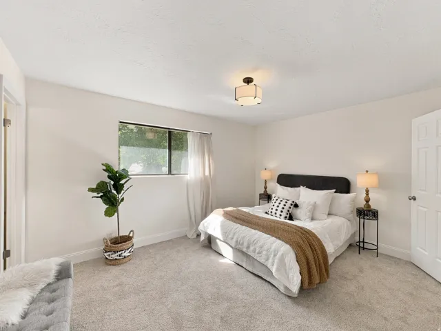 Recessed window with white trim, light-colored walls, and textured ceiling