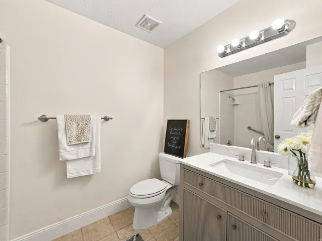 Modern vanity with an integrated sink and brushed nickel faucet, complete with a marble-finish countertop