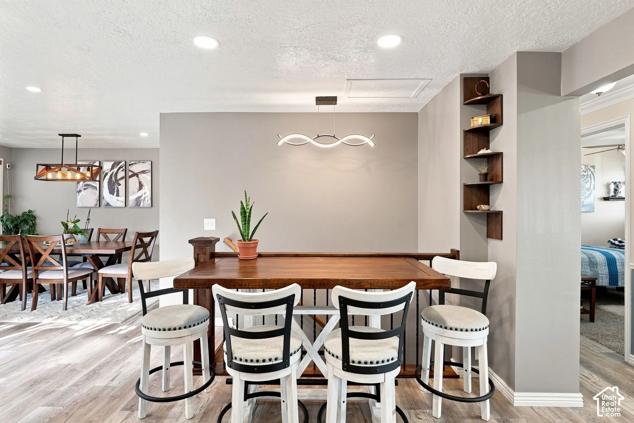 Wood-finish flooring throughout, recessed lighting, and a modern linear light fixture