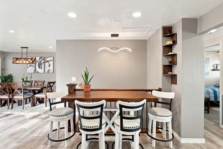 Wood-finish flooring throughout, recessed lighting, and a modern linear light fixture