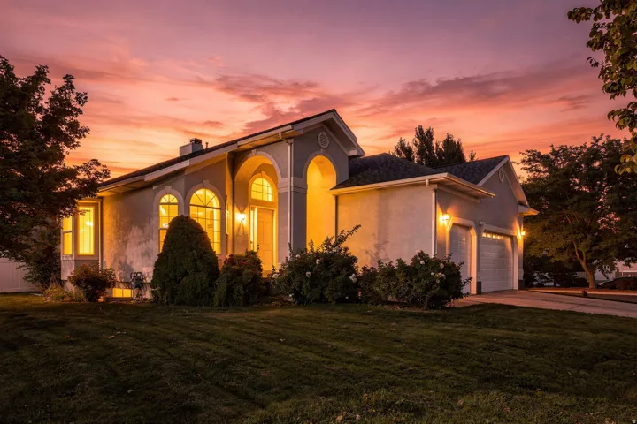 Stucco exterior with arched entryways and a two-car garage