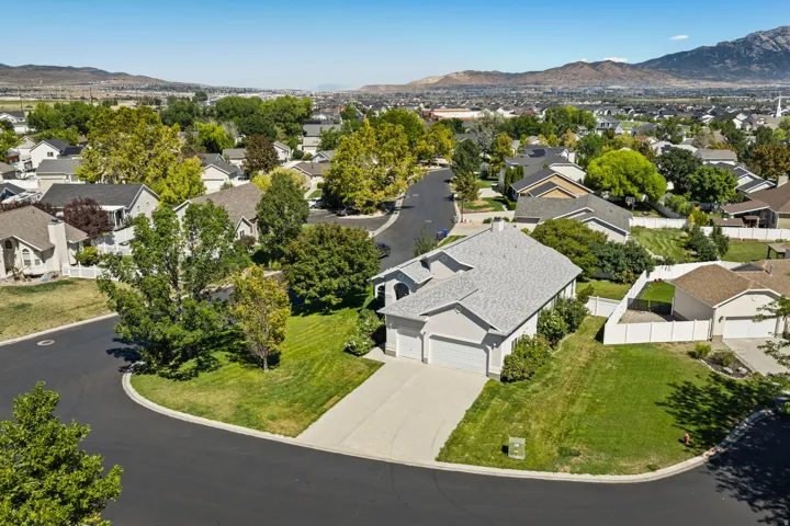 Residential property with a gray shingle roof, attached two-car garage, and concrete driveway