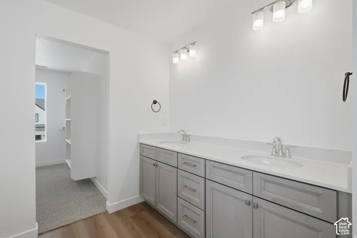 Dual vanity with undermount sinks, stone-finish countertop, and chrome fixtures