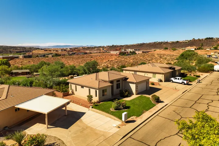 Single-story residence featuring a tile roof, stucco exterior, and an attached two-car garage