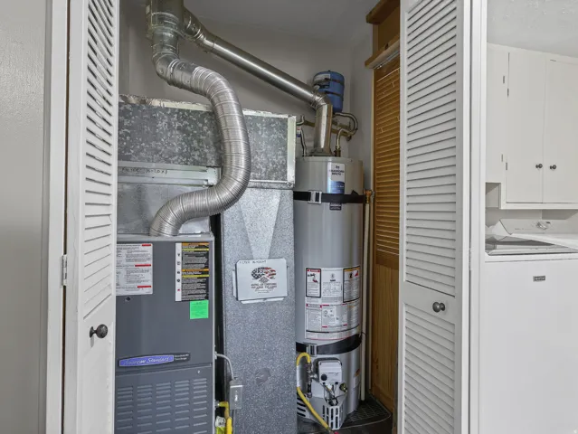 Louvered bi-fold doors enclosing a water heater and furnace