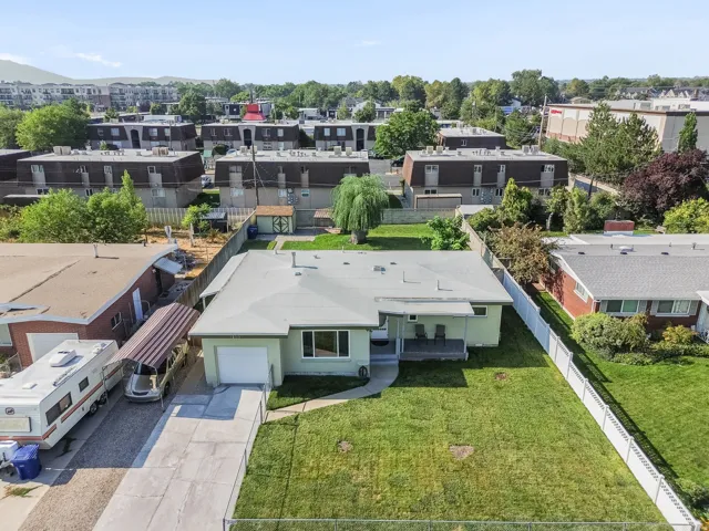 Single-story residence featuring a front lawn, paved driveway, and an attached single-car garage