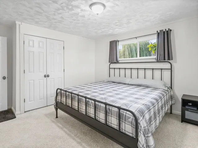 White textured ceiling with a flush-mount light fixture