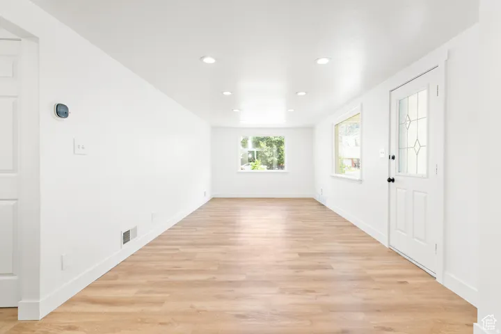 Open concept living space featuring wood-finish flooring, recessed lighting, and white trim