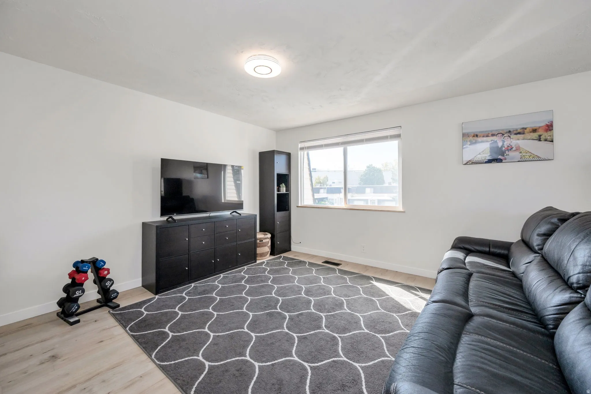Recessed lighting, new LVP flooring, and a large window with natural light