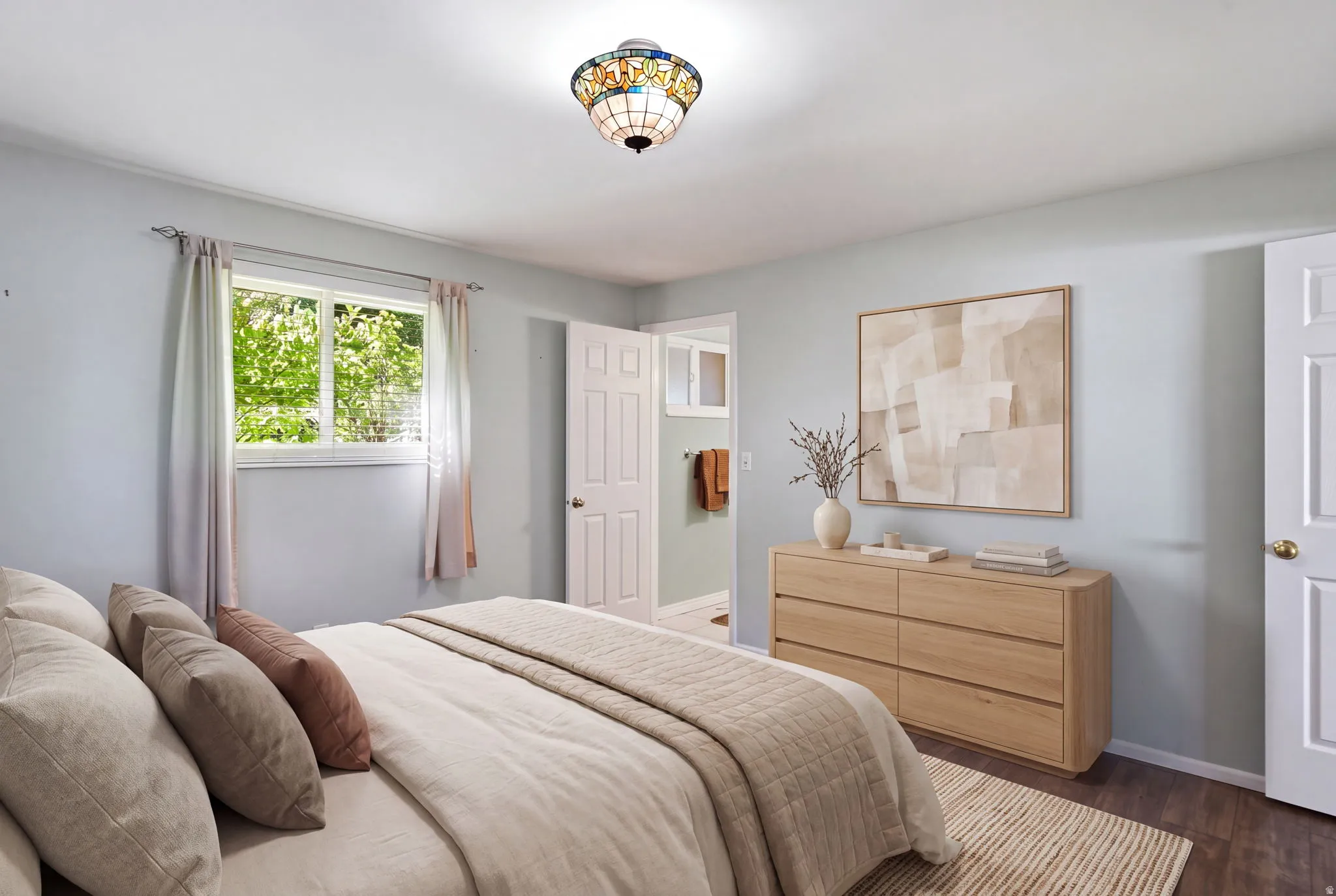 Recessed window with white trim, wood-finish flooring, and a decorative ceiling light fixture