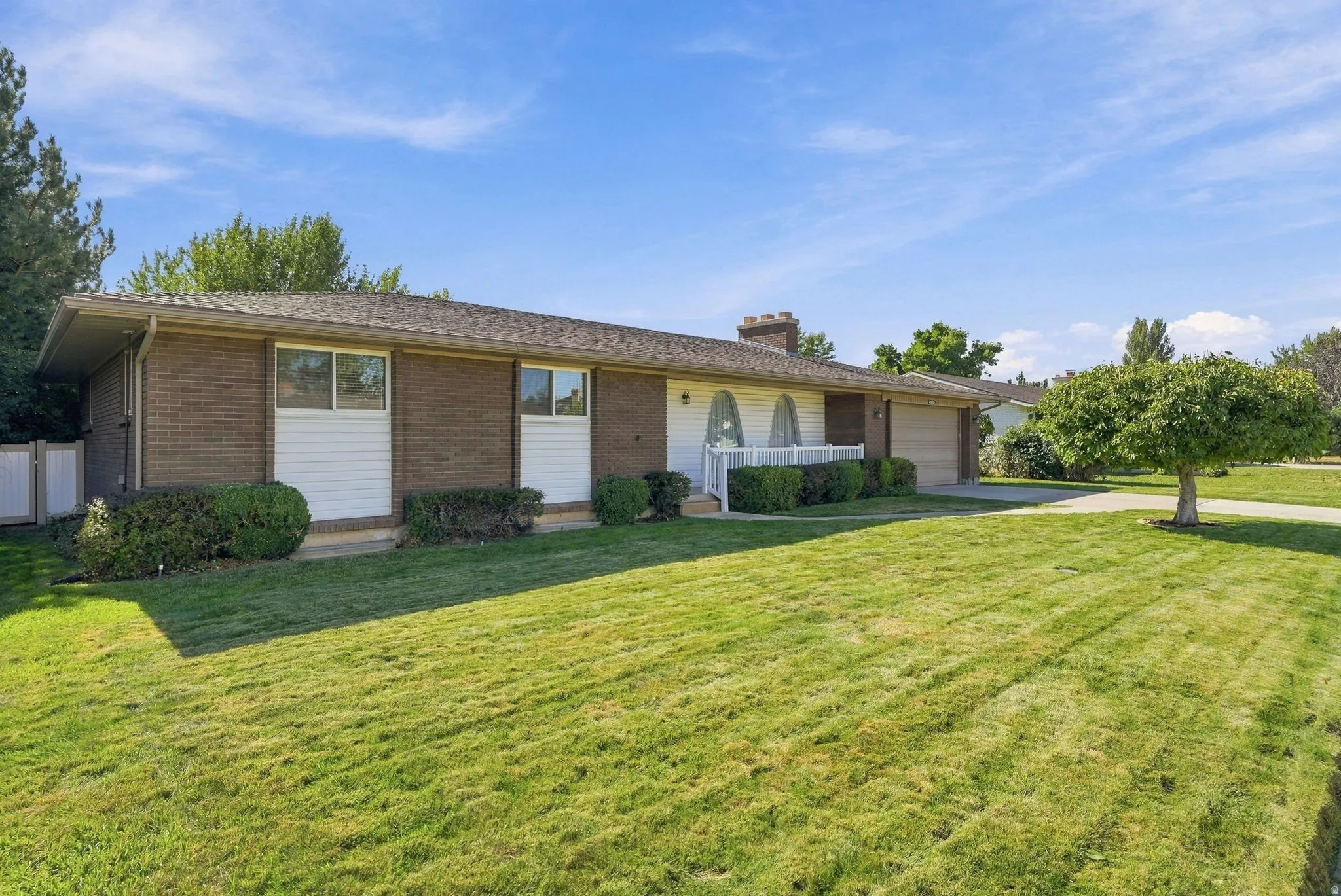 Brick exterior with white siding accents and a pitched roof