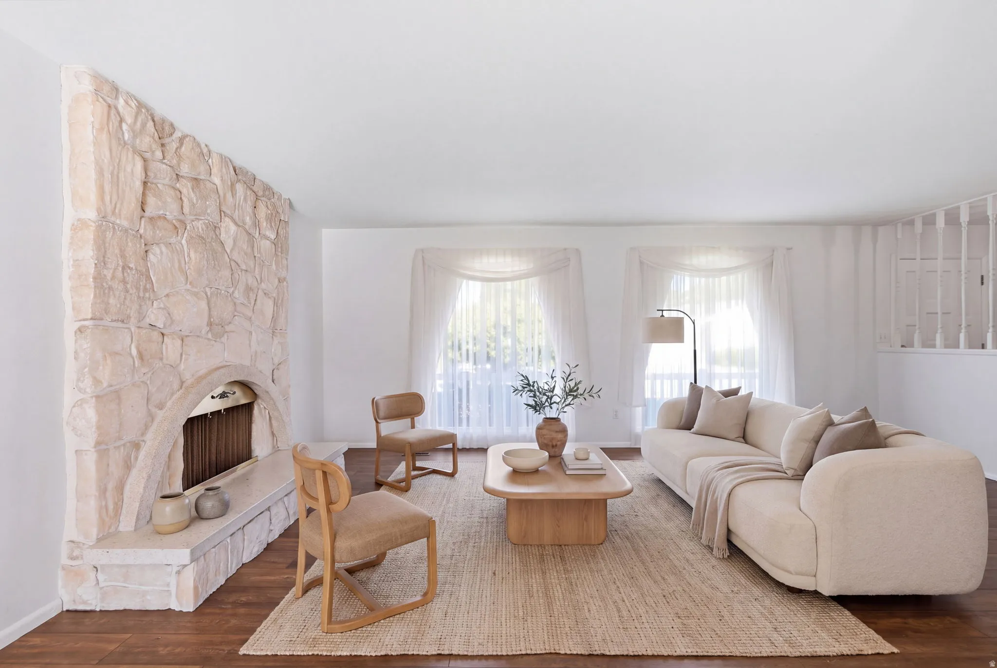 Stone-clad fireplace with an arched opening and hearth