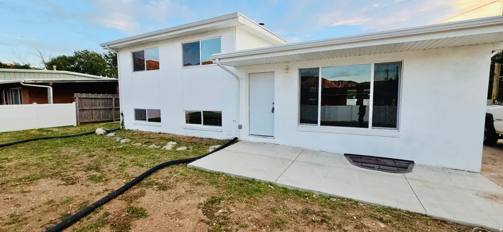 White stucco exterior with a flat roofline