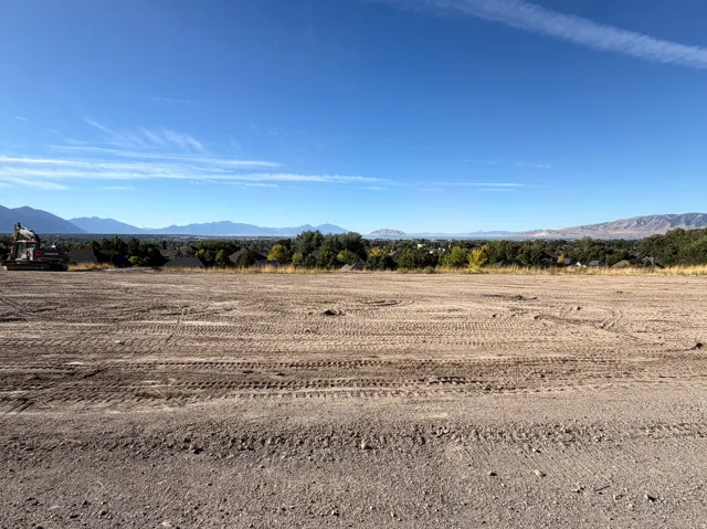 Expansive land parcel with graded terrain, offering a clear development site