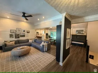 Recessed lighting illuminates the living space with a ceiling fan