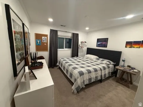 Recessed lighting, white walls, and neutral carpeting