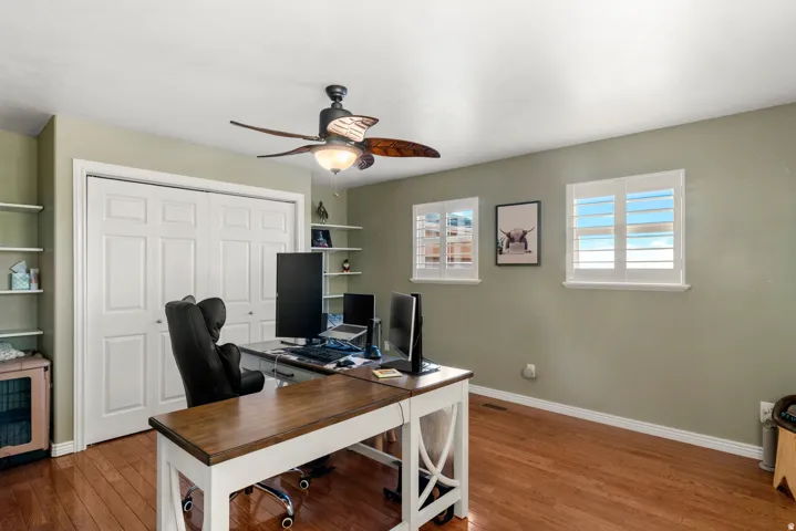 Hardwood flooring complemented by a ceiling fan with integrated lighting