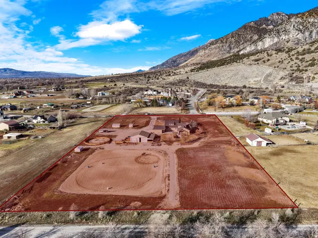 Expansive property featuring multiple outbuildings, dedicated riding arenas, and a residential structure