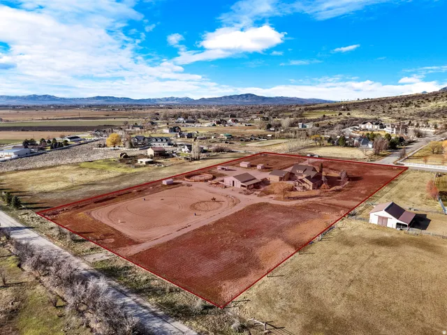 Expansive property featuring multiple outbuildings, a riding arena, and a large residential structure