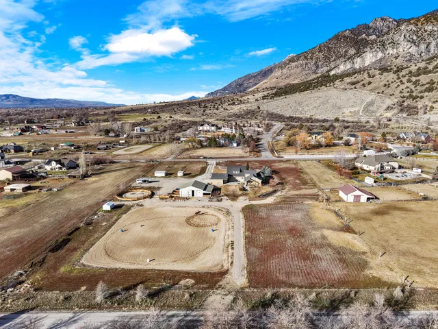 Expansive property with multiple outbuildings, fenced areas, and a circular riding arena