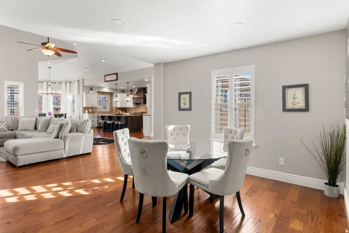 Open-concept living space featuring wood-finish flooring, recessed lighting, and a ceiling fan