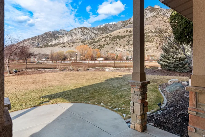 Expansive concrete patio with a stacked stone column accent