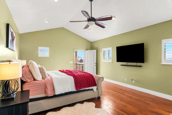 Vaulted ceilings with recessed lighting, wood-finish flooring, a ceiling fan, and window shutters