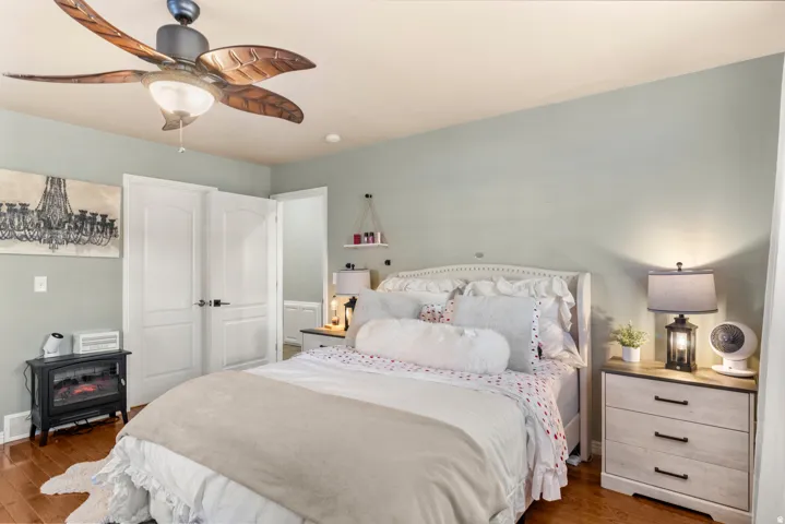 Recessed lighting, wood-finish flooring, ceiling fan with integrated lighting, built-in shelving, paneled interior doors