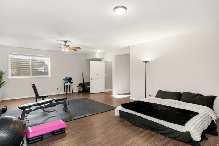 Wood-finish flooring throughout, bright walls, and a recessed ceiling light
