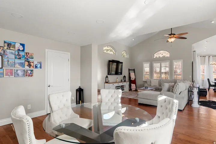 Vaulted ceilings with recessed lighting, wood-finish flooring, and multiple arched windows