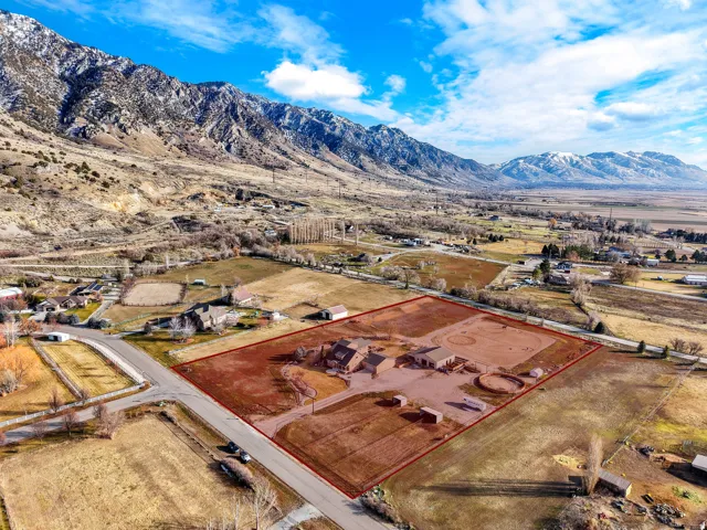Expansive property featuring a main residence, multiple outbuildings, and a horse arena