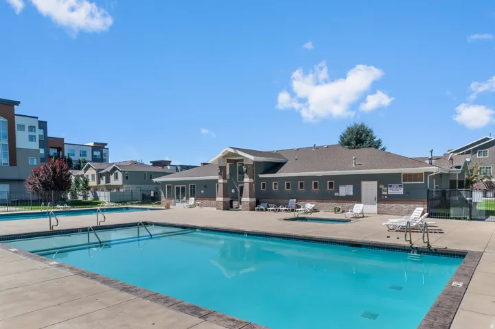 Expansive outdoor swimming pool with surrounding concrete decking